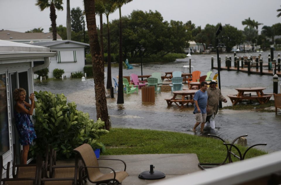  Residents of the Sandpiper Resort survey the rising water coming from the Gulf of Mexico