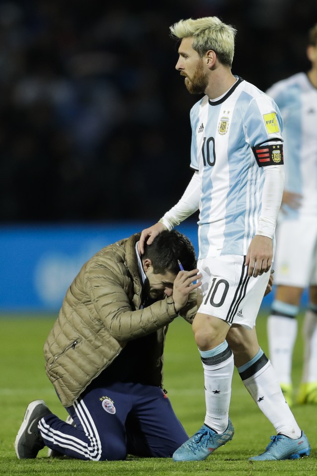  A fan ran onto the pitch and kneels to the feet of Messi