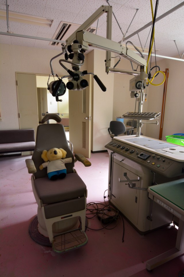 A spooky stuffed toy sits in an inspection chair