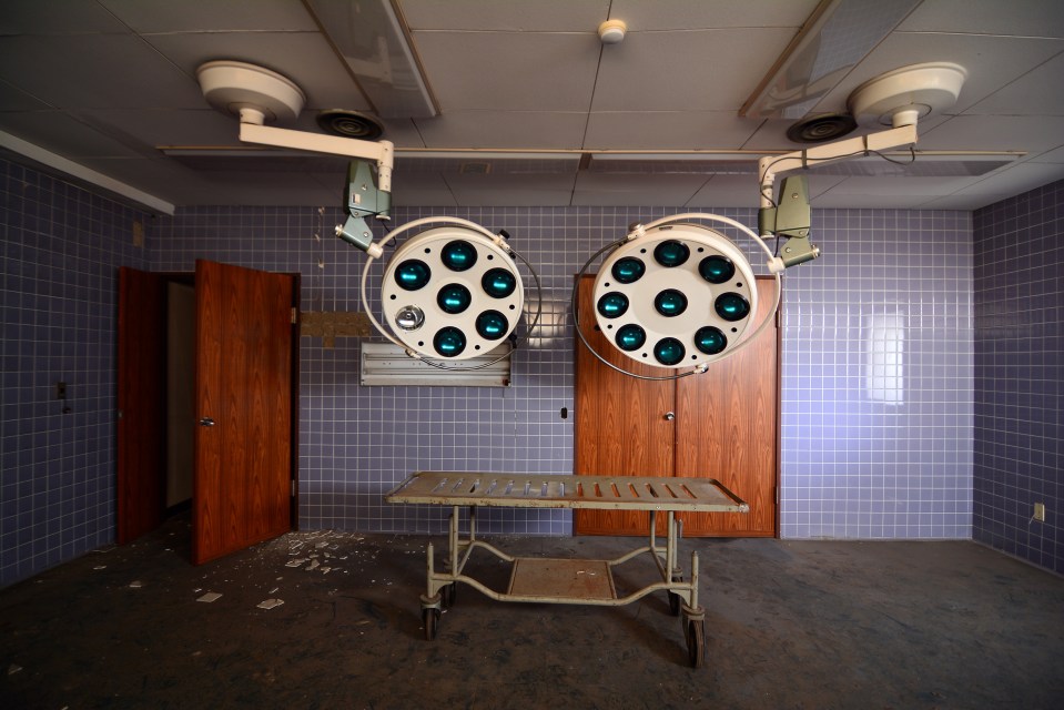 Surgical lights and a stretcher in an abandoned hospital in Kanto