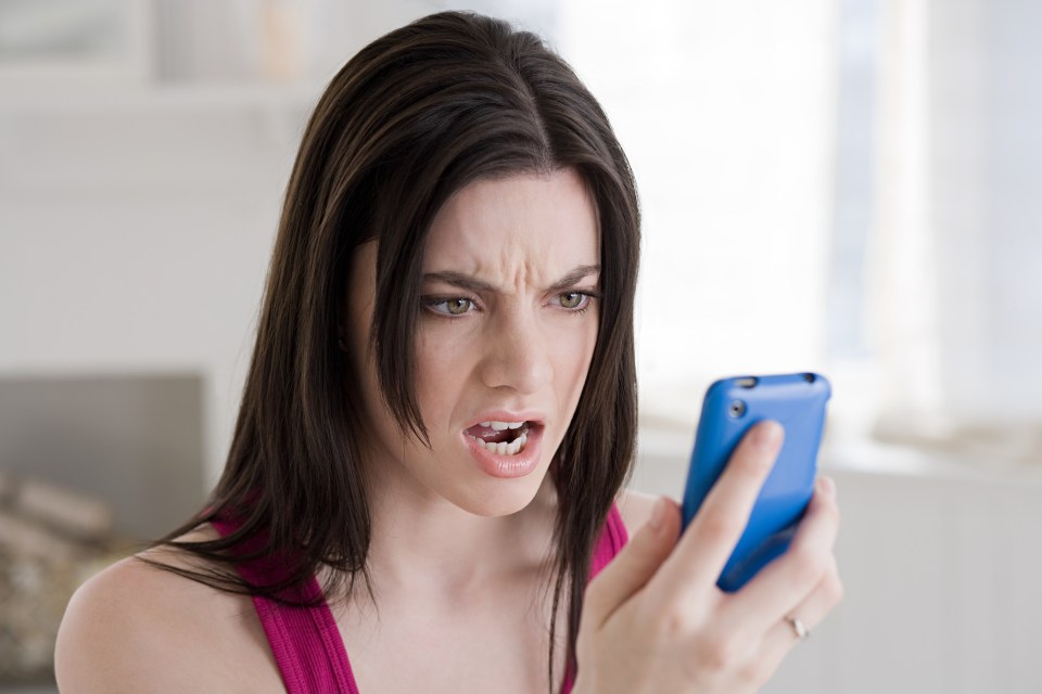 Angry woman looking at cellphone