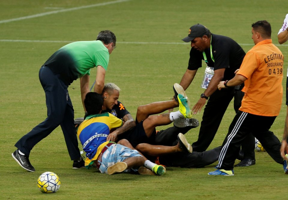 Neymar is wrestled to the floor as fans are desperate to be with their idol