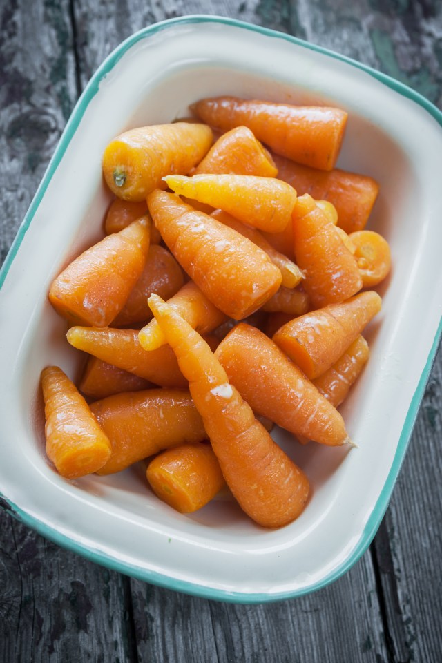 Buttered carrots in blue enamelware tray