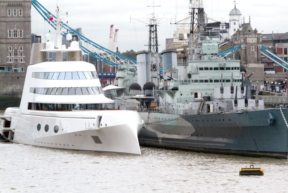 Superyacht moors on The Thames in London next to HMS Belfast