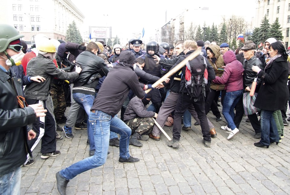 Pro-Russian protesters (L) clash with activists (R) supporting the territorial integrity of Ukraine 