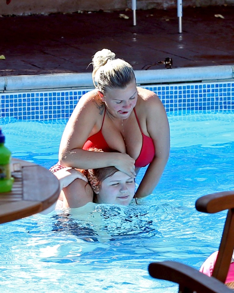  Kerry was seen drinking in the sun and playing in the pool with her children