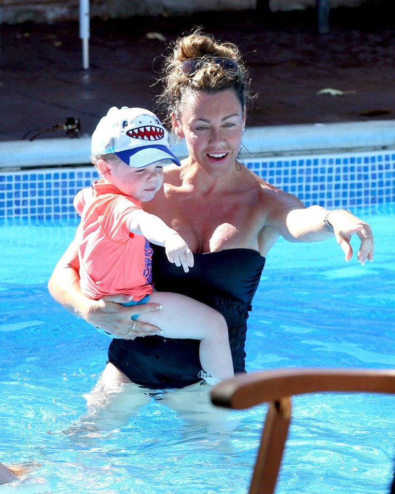  Michelle opted to be with son Aaron at a quieter part of the pool