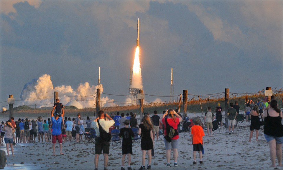 Hundreds of people pack the Canaveral National Seashore in Cape Canaveral, to witness the launch