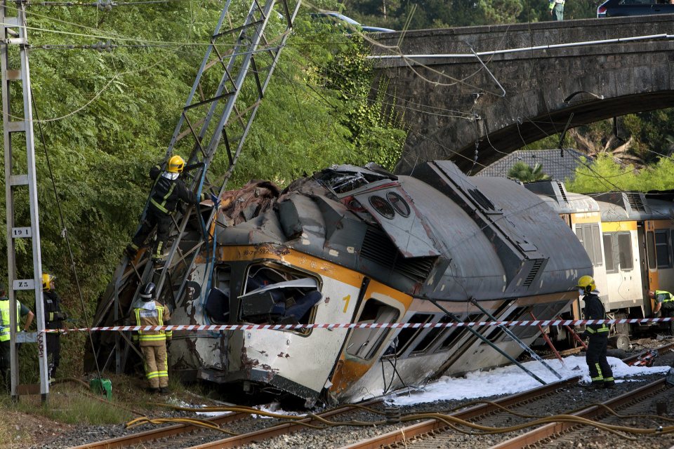  The mangled train wreckage lies next to the tracks and steel turret it piled into this morning