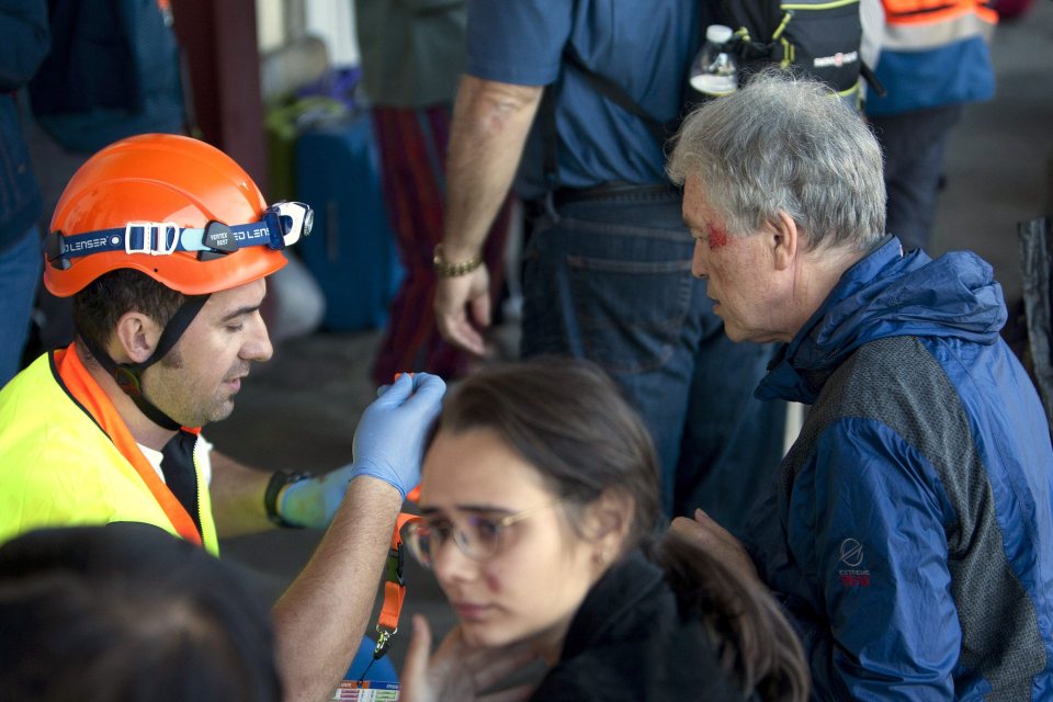  A passenger with a grazed head is treated by paramedics at the scene