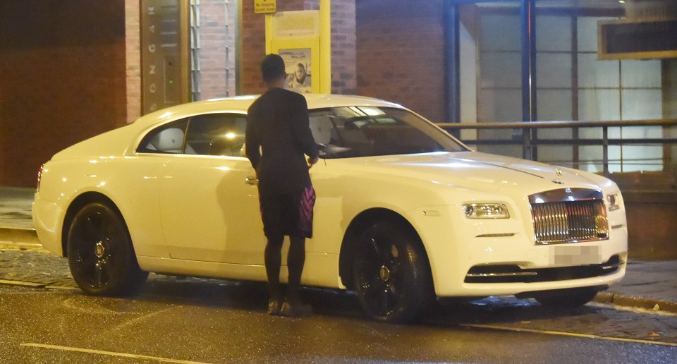 Daniel Sturridges seems unaware of the no stopping sign above his car as he locks up his £235,000 Rolls Royce