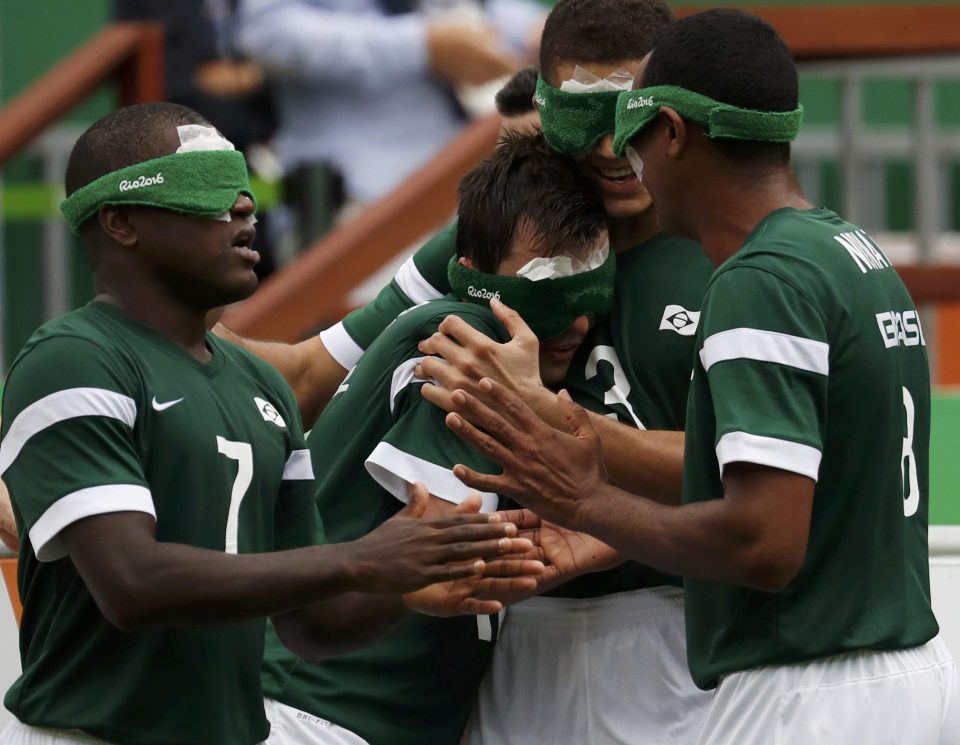 Ricardinho celebrates with team mates after scoring