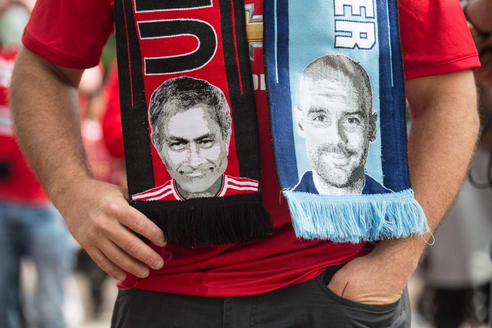 A fan wears a scarf bearing images of Jose Mourinho and Pep Guardiola