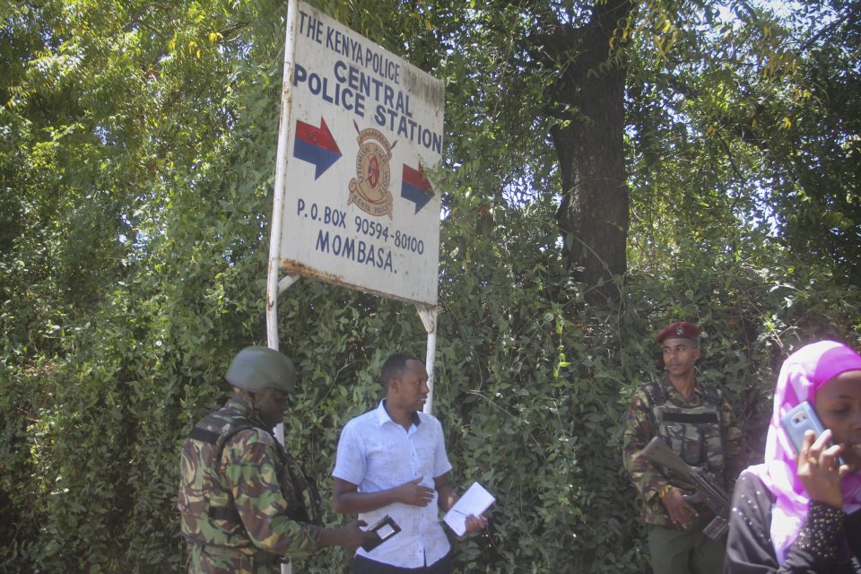 A soldier and a police officer stand guard at the Central Police Station 