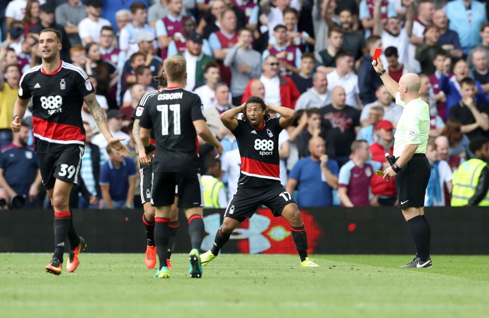  Pereira recoils in shock after he is shown a second yellow, and subsequently a red, after celebrating with the Forest fans