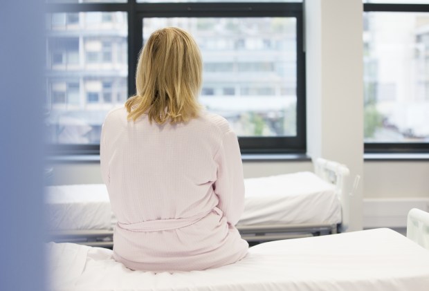 Patient sitting on hospital bed