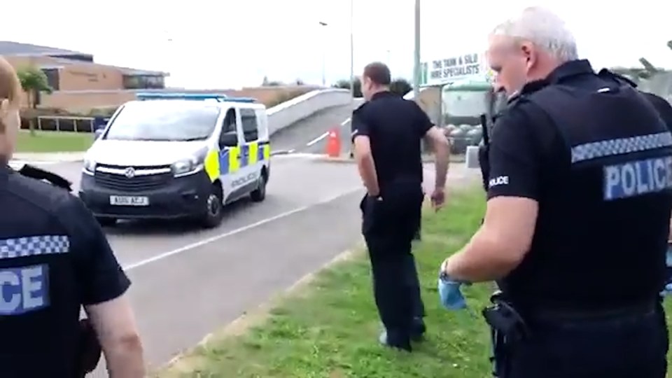  Officers stand nearby during the bizarre standoff