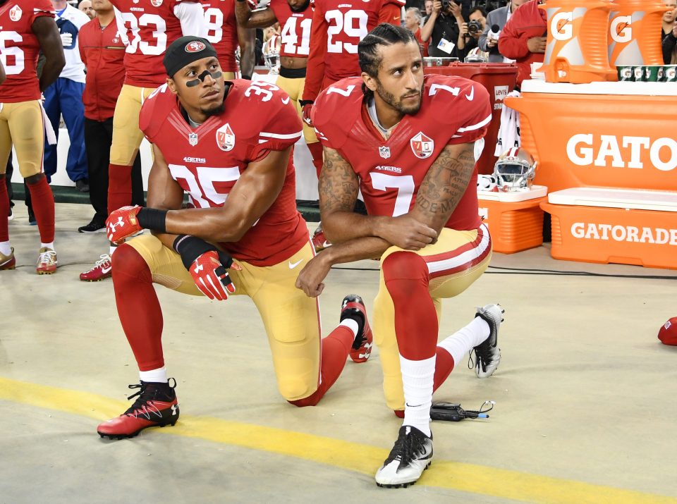  Colin Kaepernick, right, and Eric Reid kneel in protest during the national anthem