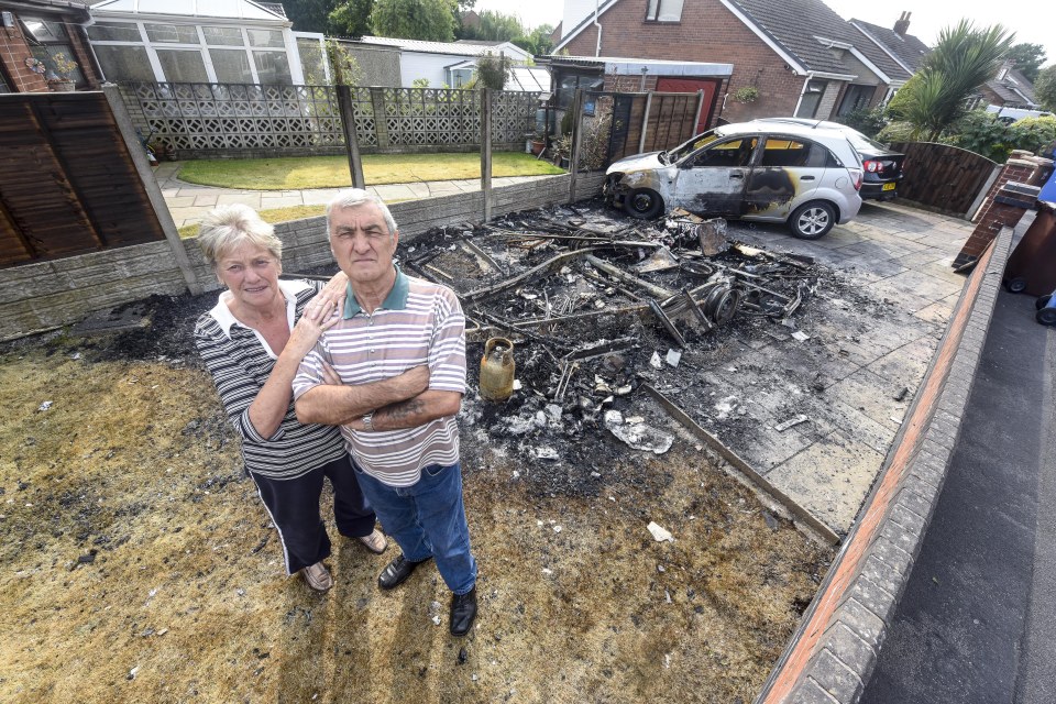  Colin and Jean White stand next to the remains of their destroyed holiday caravan