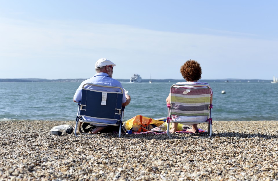  A couple bask in the sunshine on Southsea beach this afternoon