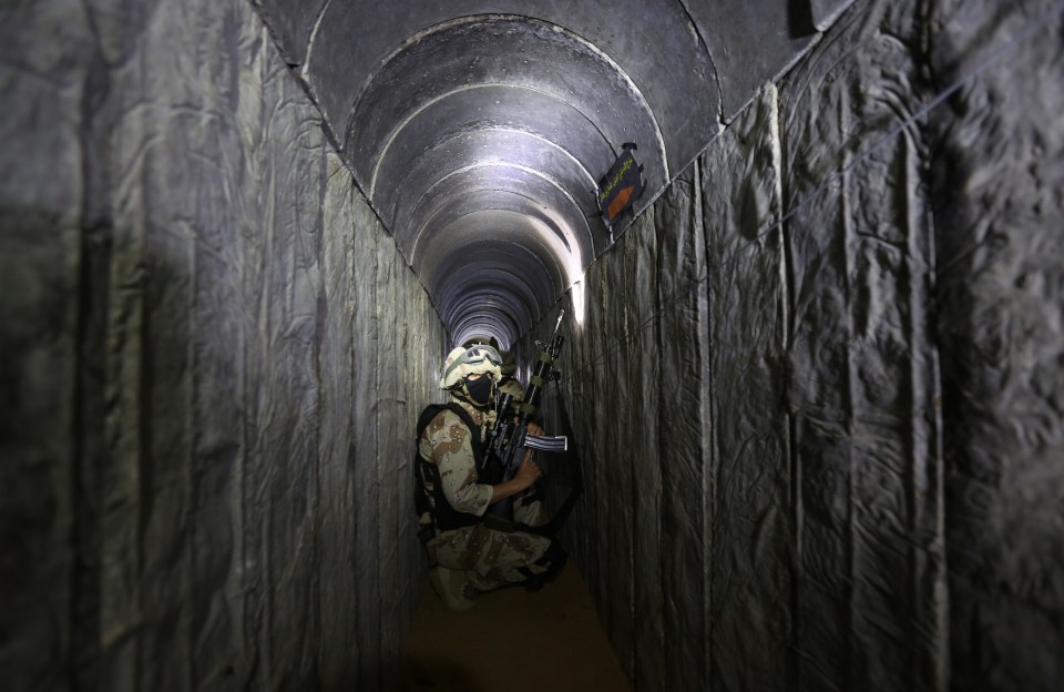 A Palestinian militant squats in one of the subterranean tunnels