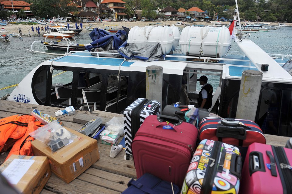  Tourists' luggage is seen on the dock next to the boat that exploded