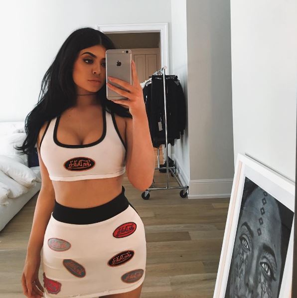 She has followed the lead of sisters Kim and Kourtney by strapping on the corset-style device while going on walks