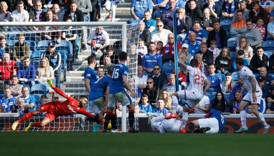 Wes Foderingham does well to keep the ball out diving low to his left