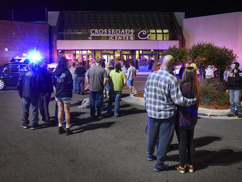  Locals stand near the mall entrance where the bloody knife attack occurred