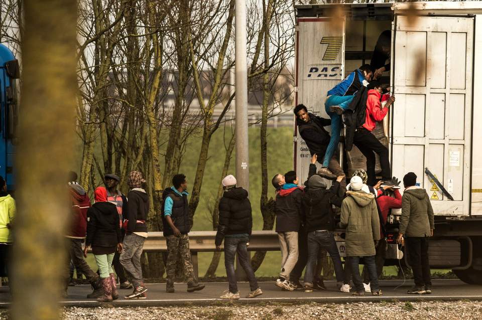  Officials hope the wall will stop migrants from trying to sneak onto trucks bound for Britain