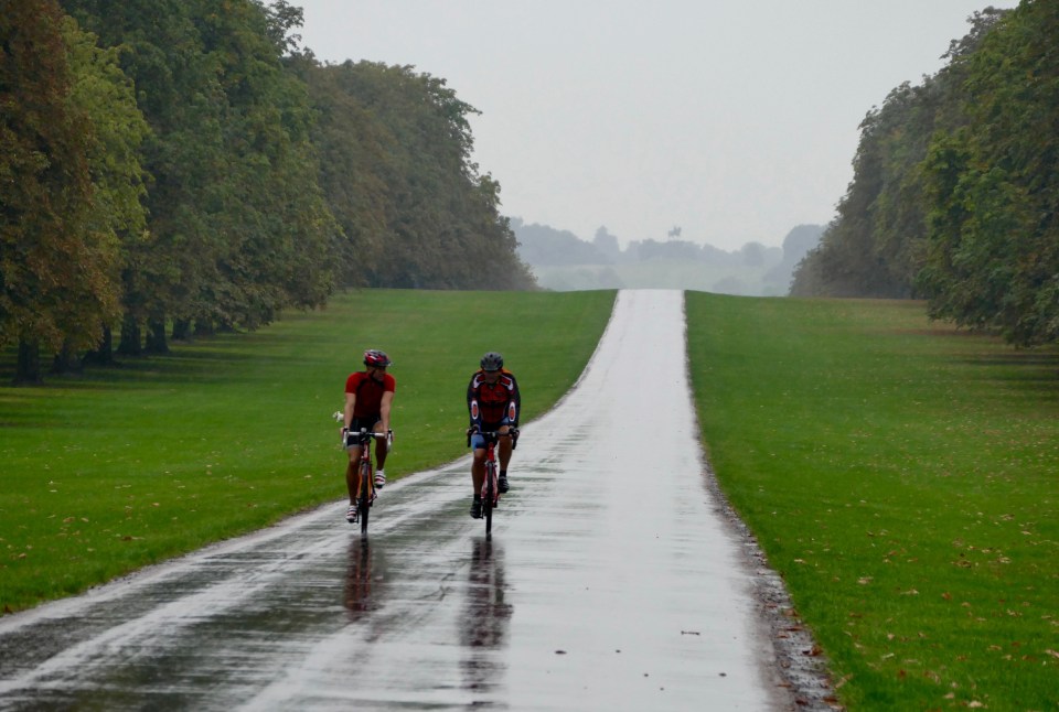  More of Britain will see rainy and windy conditions from the end of this week - here people brave the drizzle in Windsor