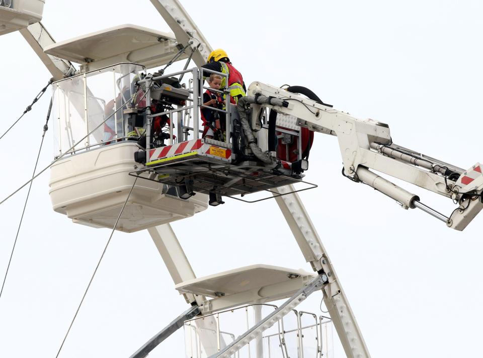 Emergency crews were forced to cordon off the area as they figured out how to bring the pair down from the Solent Ferris wheel