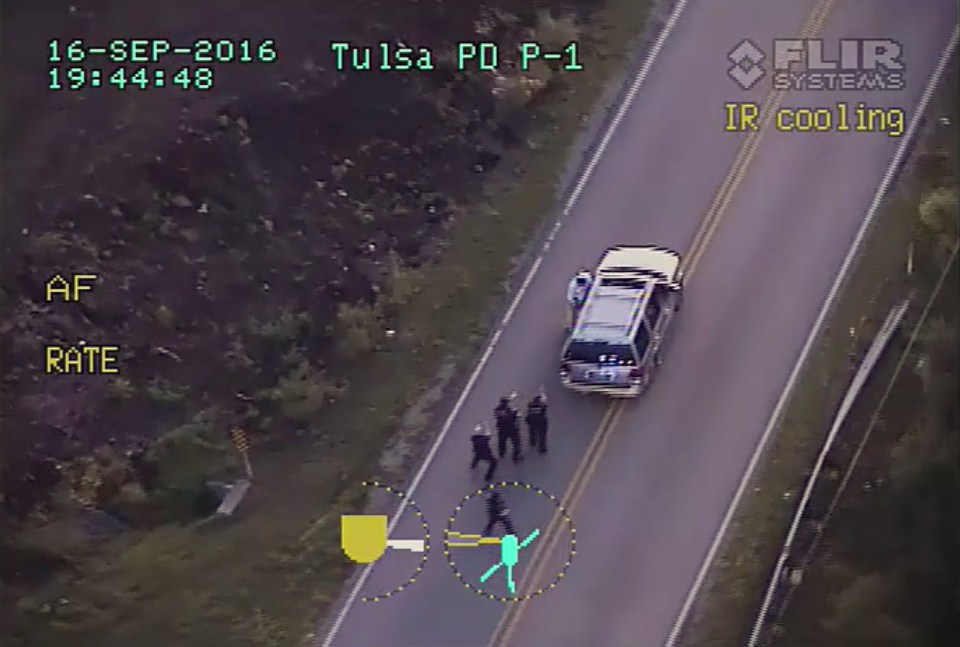  Crutcher, top, is pursued by police officers as he walks to his vehicle in Tulsa