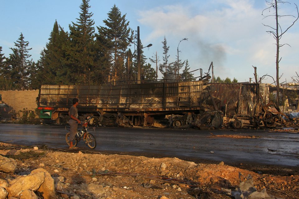  A boy inspects a damaged aid truck after the devastating airstrike