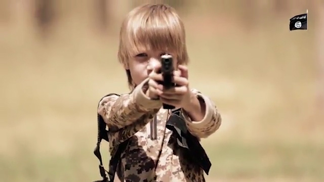  A young boy shooting a prisoner in an ISIS video