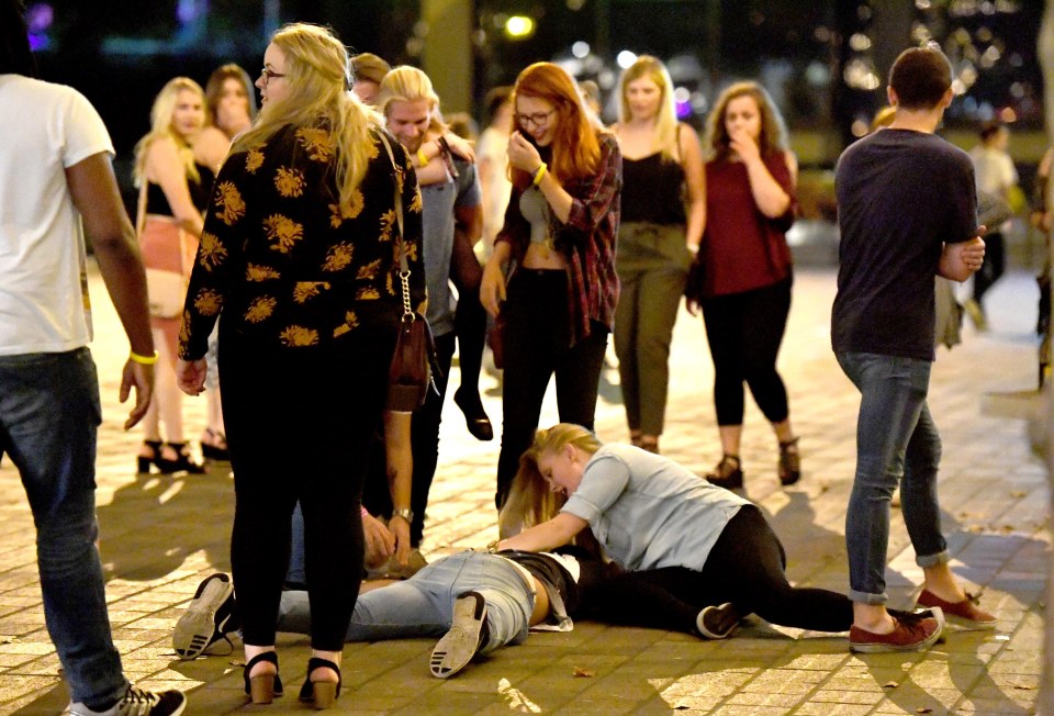  Giggles all round as a Portsmouth reveller falls over, presumably from too much to drink, as a friend tries to rally them to get up