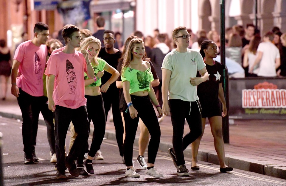  A gaggle of new Portsmouth students walk arm in arm down the street of bars as they look for the next place to move on to