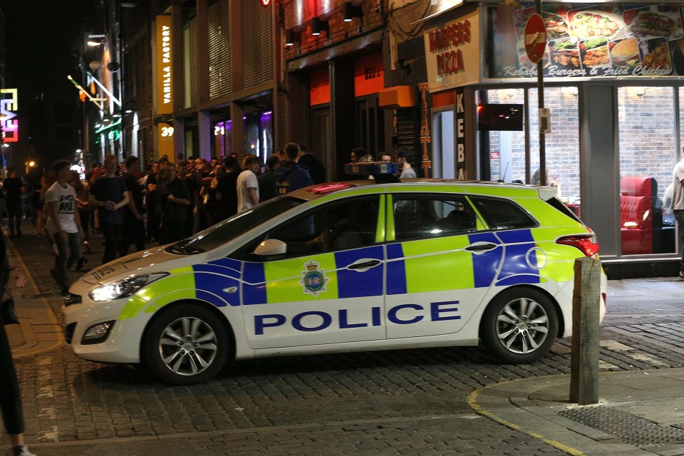  Police watch on in a Liverpool street as hundreds of new students pour into the town