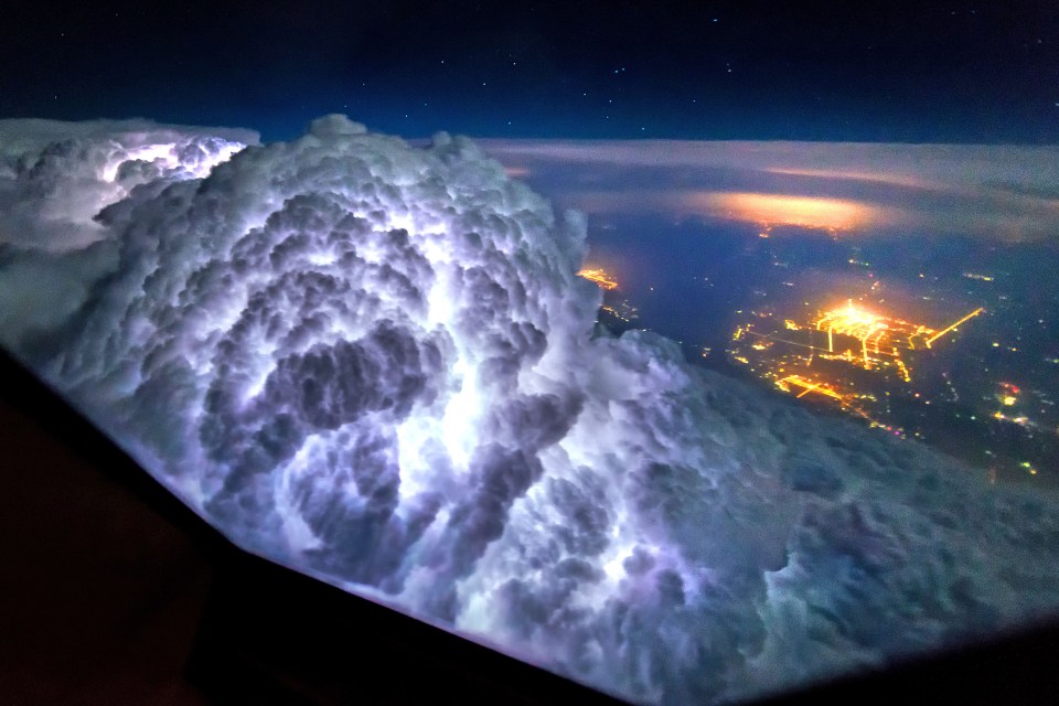 Amazing snaps taken from plane cockpits show thunderstorms light up the insides of clouds