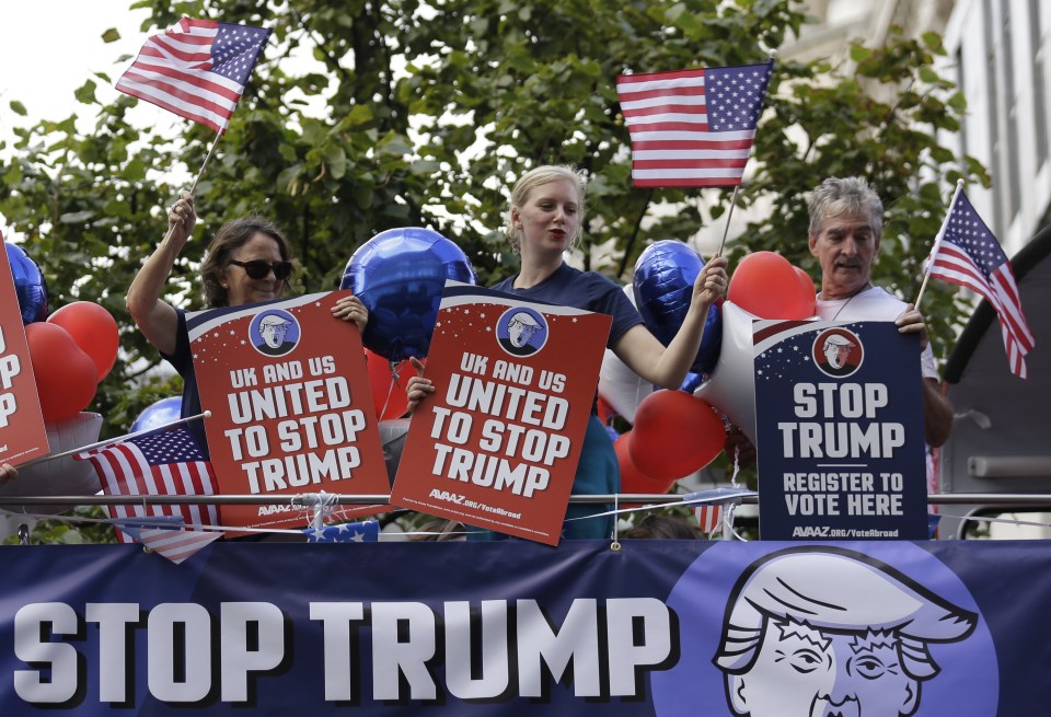  Opponents of American presidential candidate Donald Trump travel aboard an open-top double decker bus