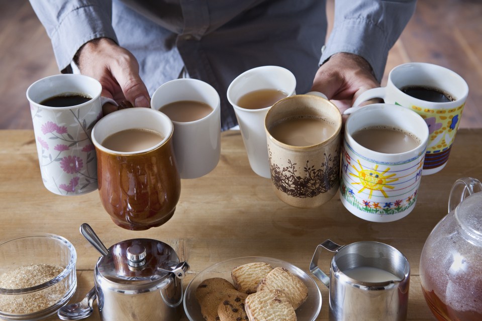 Man holding many tea and coffee cups