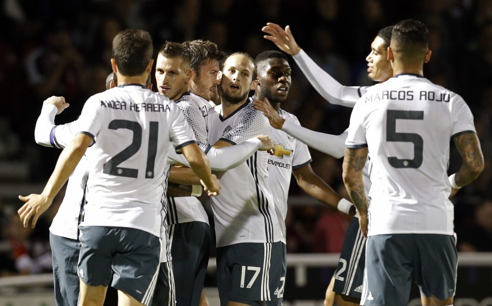 Manchester United players congratulate Michael Carrick after he gave them the lead at Northampton