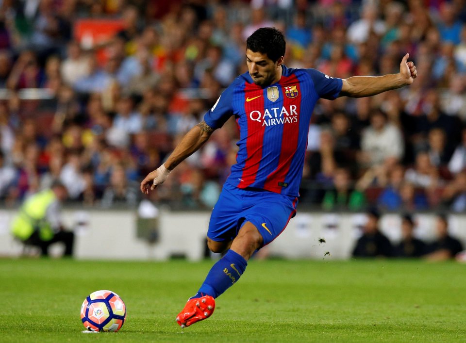  Teammate Luis Suarez leads the attack through the middle