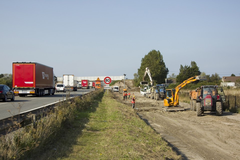  The mile-long wall stretches along the main motorway leading to the ferry port and was set to be finished by Christmas