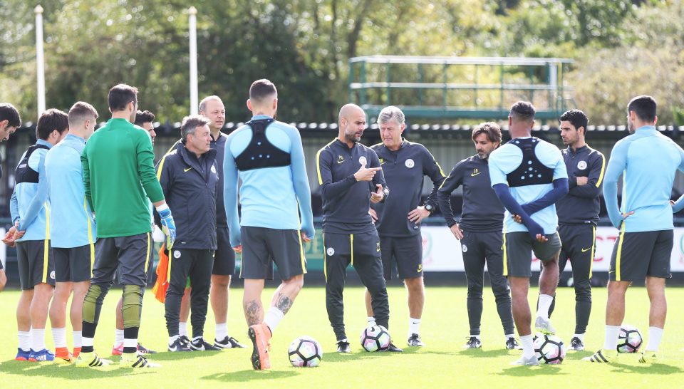  Manchester City boss Pep Guardiola addresses the team before training