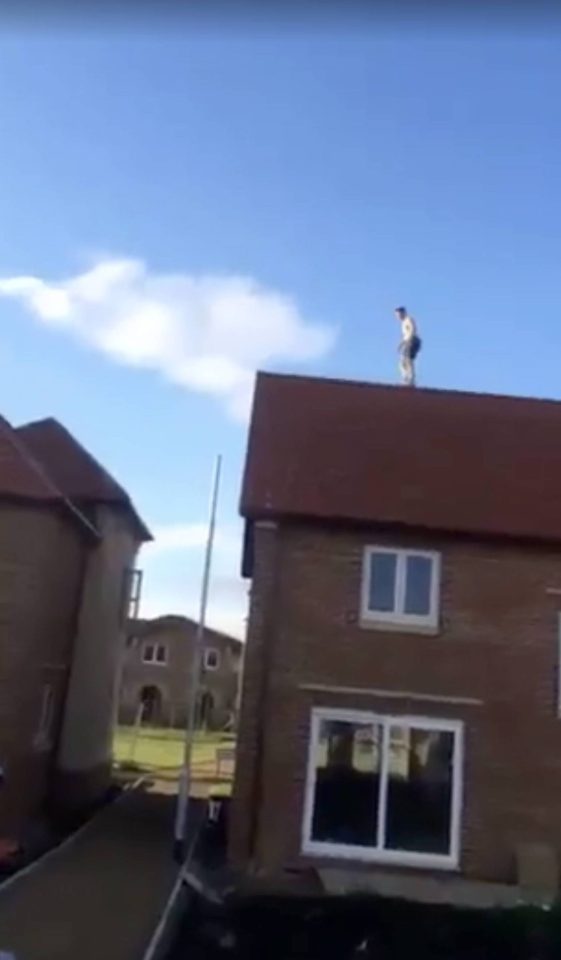 A reckless youngster was filmed jumping a massive gap between two 20 foot houses 