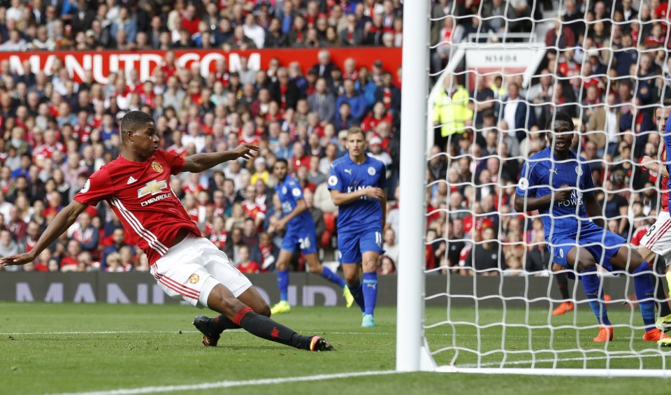 Marcus Rashford slides home for United's third goal