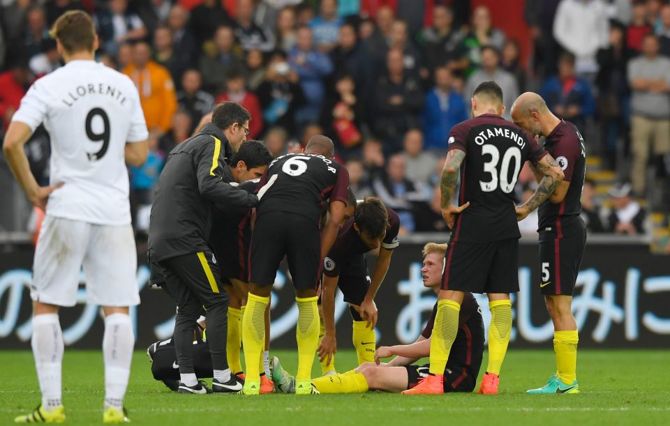 The Manchester City team check that Kevin De Bruyne is okay after being fouled during the Swansea here