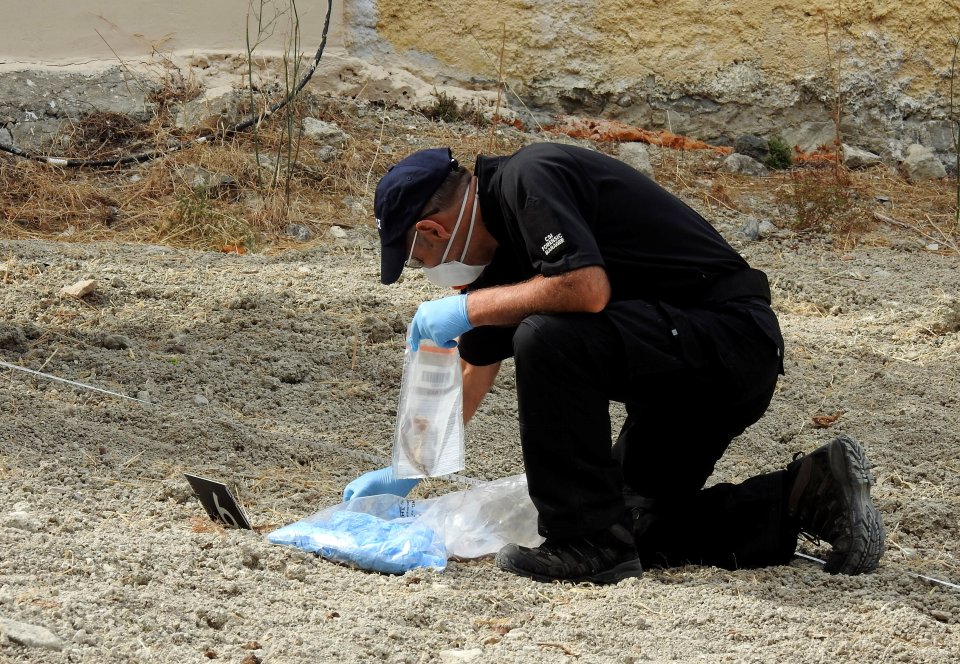  A South Yorkshire police officer investigates the ground before commencing excavating a site for Ben Needham