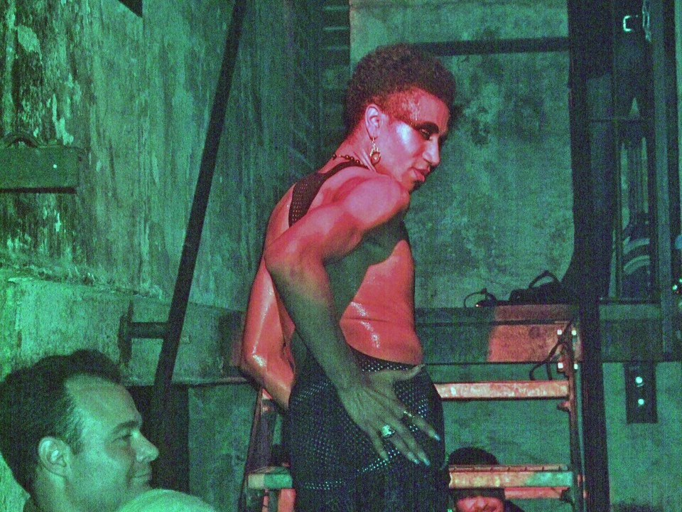 A man covered in paint dances in the infamous German club